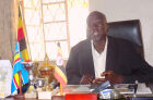 The Kitgum Resident Districh Commissioner, Mr Komakech in his office in Acholi land.<br />These NRM administrators had to find a way to survive as essential commodity prices were raising all over the country. For suffering citizens of this country, who are bitter with government corruption that continues to increase by the day, such government officials must not have their fingers cut off for the time being as it has been suggested many times before. Now that they have eaten the PDM money as they have always been doing with much of the rest of the funds for such projects any way, they should be left to continue working so that they can try to pay back this loss as soon as possible.<br />In Uganda it is quiet clear that the Inspector of government business has failed to prosecute these officials and to stop them from continuing to misappropriate public funds left, right and center. This sort of failure by the government should be able to send a message to the international donors who are anxious to want to help this country not to continue to spend and lend this government any financial assistance. Unfortunately if they continue to do so as the USA, China and the United Nation do so, they are doing it at their own peril. Africa and its poverty is unable to continue to remove African tyrannical regimes by fighting costly civil wars.